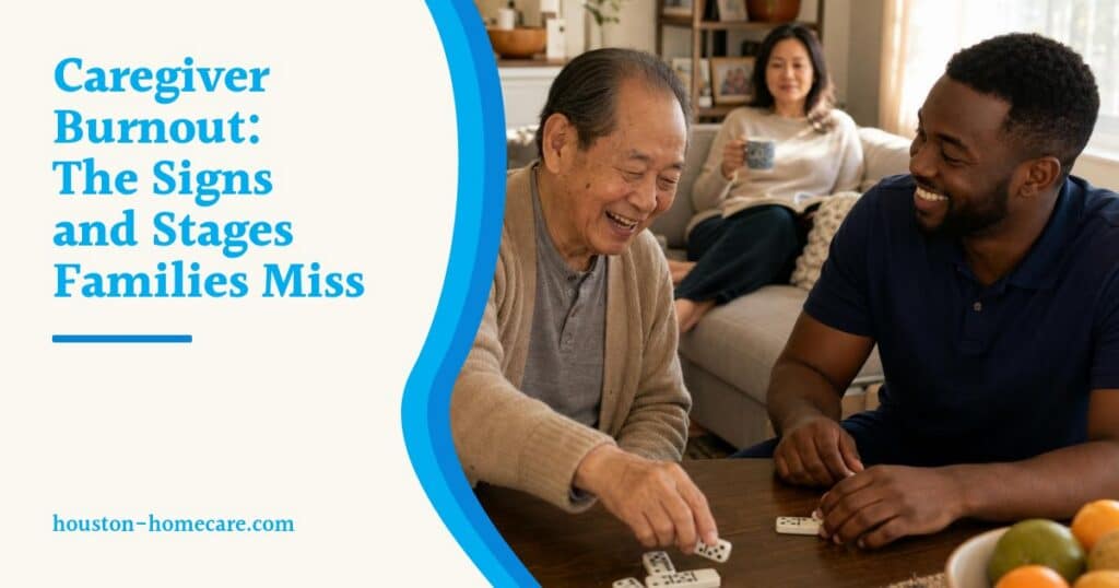 An older man plays dominoes with his home caregiver while his daughter relaxes with tea on the sofa behind them.